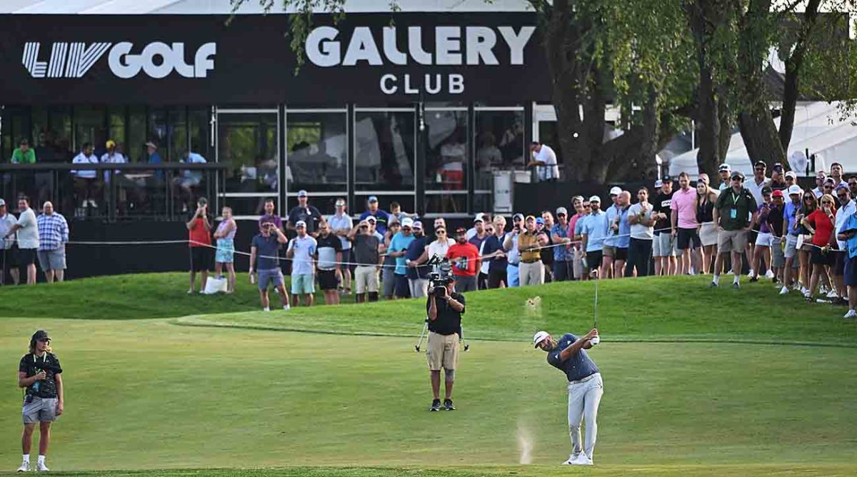 Dustin Johnson hits a shot in front of cameras at the 2022 LIV Golf Chicago event.